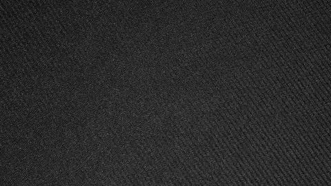 The texture of the fabric is dark gray. Stock Photos
