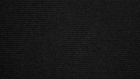 The texture of the fabric is dark gray. Stock Photos