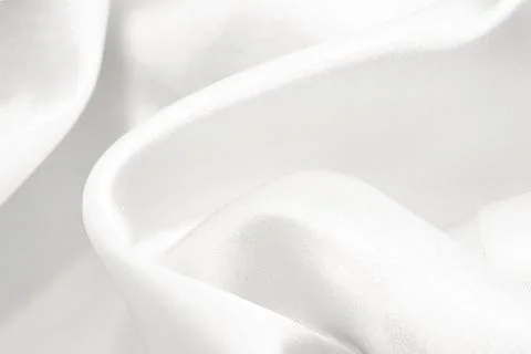 The texture of a fabric made of silk or calico with waves and rumples. Text.. Stock Photos