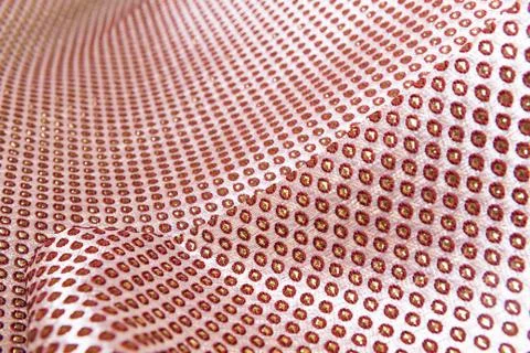 Texture of the fabric, side, background of fabric in the highlight. golden color 库存照片