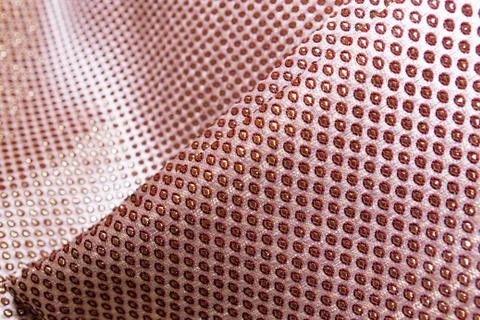 Texture of the fabric, side, background of fabric in the highlight. golden color Stock Photos