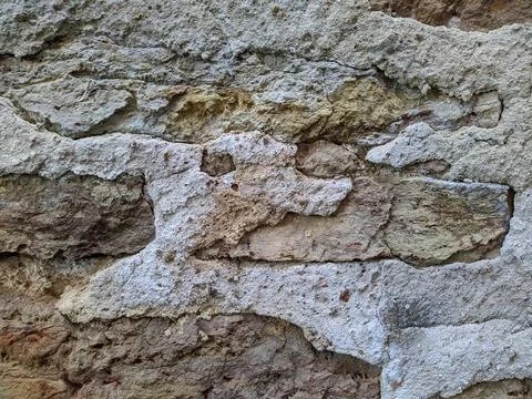 Texture of the facade of a building made of old stones Stock Photos