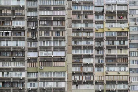 Texture of the facade of a multi-storey residential building with windows and Stock Photos