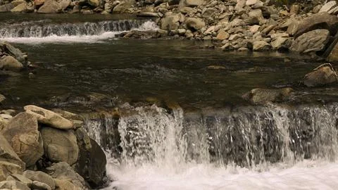 Texture of a falling water of a waterfall in a river Stock Photos