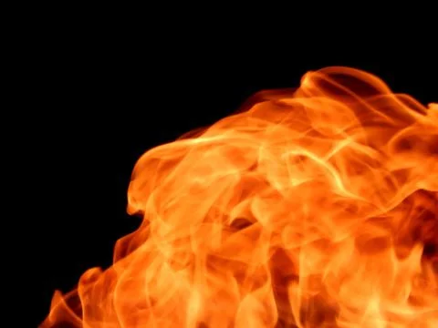 The texture of a fiery flame of fire on a black background Stock Photos