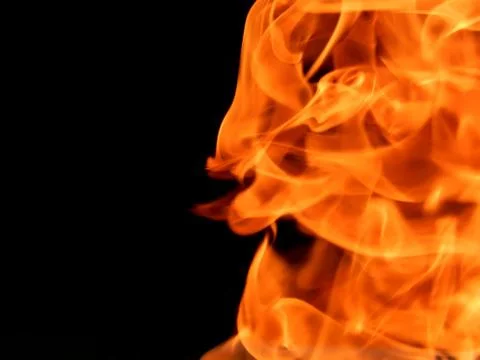 The texture of a fiery flame of fire on a black background Stock Photos