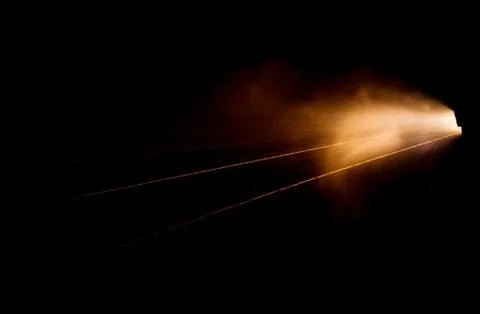 The texture of a firearm shot , a bright flash of flame on a black background Stock Photos