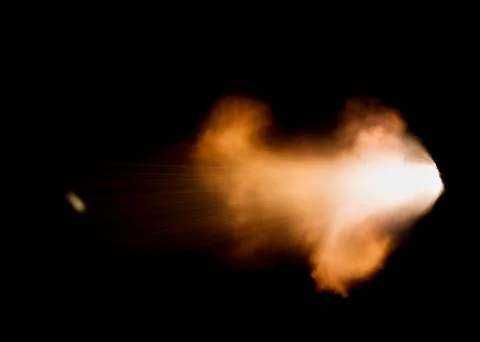 The texture of a firearm shot , a bright flash of flame on a black background Stock Photos