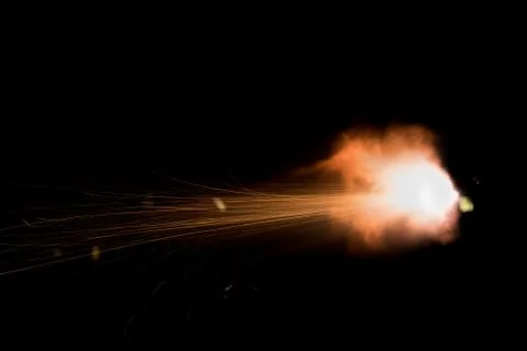 The texture of a firearm shot , a bright flash of flame on a black background Stock Photos
