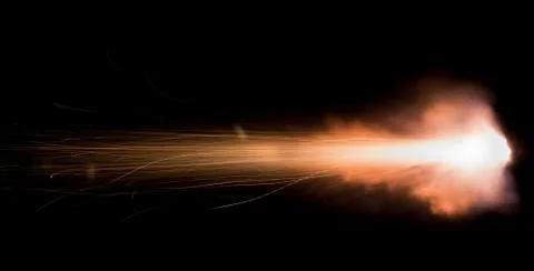 The texture of a firearm shot , a bright flash of flame on a black background Stock Photos