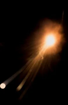 The texture of a firearm shot , a bright flash of flame on a black background Stock Photos