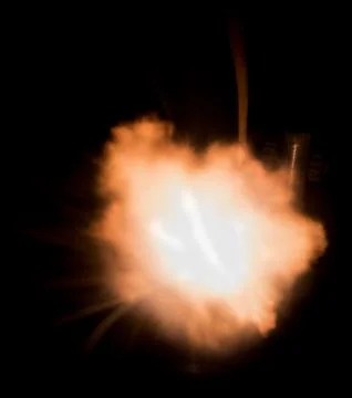The texture of a firearm shot , a bright flash of flame on a black background Stock Photos