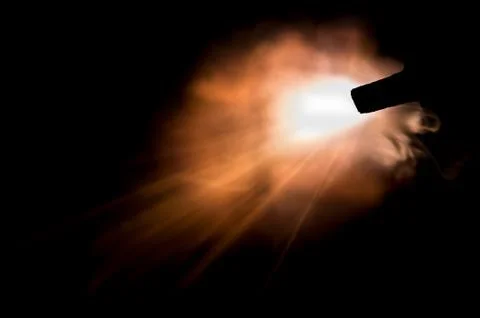 The texture of a firearm shot , a bright flash of flame on a black background Stock Photos