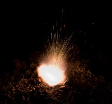 The texture of a firearm shot , a bright flash of flame on a black background Stock Photos