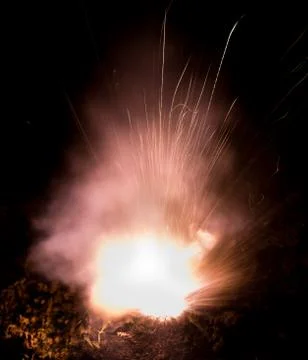 The texture of a firearm shot , a bright flash of flame on a black background Stock Photos