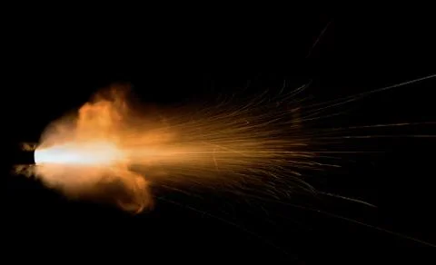 The texture of a firearm shot , a bright flash of flame on a black background Stock Photos
