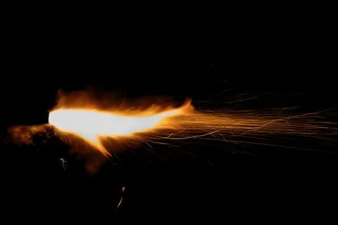 The texture of a firearm shot , a bright flash of flame on a black background Stock Photos
