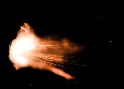 The texture of a firearm shot , a bright flash of flame on a black background Stock Photos
