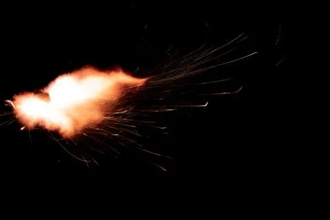 The texture of a firearm shot , a bright flash of flame on a black background Stock Photos