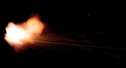The texture of a firearm shot , a bright flash of flame on a black background Stock Photos