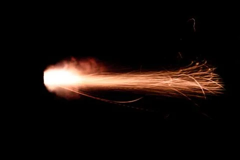 The texture of a firearm shot , a bright flash of flame on a black background Stock Photos