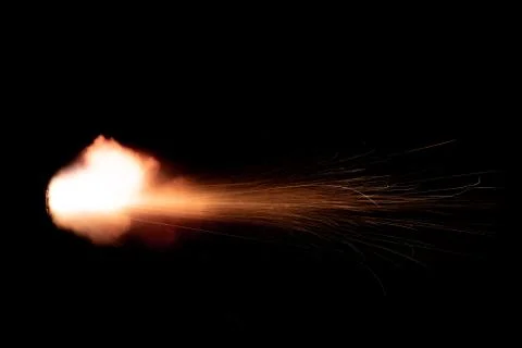 The texture of a firearm shot , a bright flash of flame on a black background Stock Photos