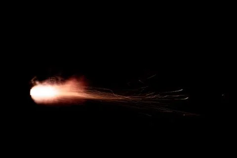 The texture of a firearm shot , a bright flash of flame on a black background Stock Photos
