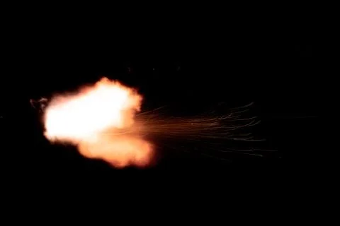 The texture of a firearm shot , a bright flash of flame on a black background Stock Photos