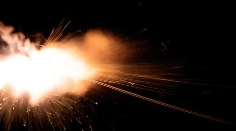 The texture of a firearm shot , a bright flash of flame on a black background Stock Photos