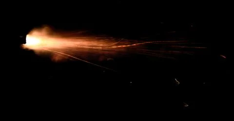 The texture of a firearm shot , a bright flash of flame on a black background Stock Photos