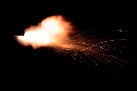 The texture of a firearm shot , a bright flash of flame on a black background Stock Photos