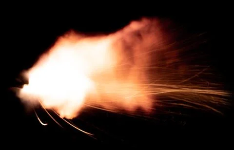 The texture of a firearm shot , a bright flash of flame on a black background Stock Photos