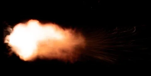 The texture of a firearm shot , a bright flash of flame on a black background Stock Photos
