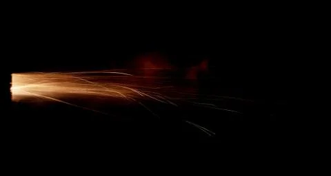 The texture of a firearm shot , a bright flash of flame on a black background Foto stock