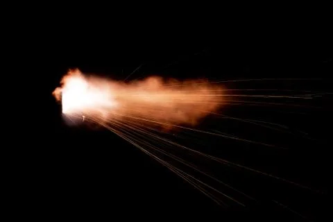 The texture of a firearm shot , a bright flash of flame on a black background Stock Photos