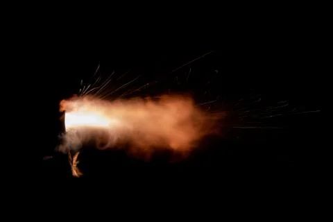 The texture of a firearm shot , a bright flash of flame on a black background Stock Photos