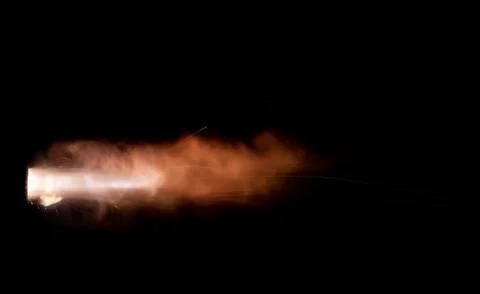 The texture of a firearm shot , a bright flash of flame on a black background Stock Photos
