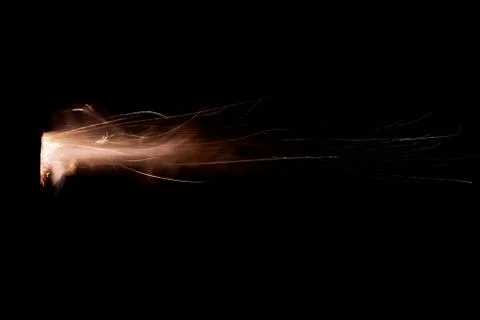 The texture of a firearm shot , a bright flash of flame on a black background Stock Photos