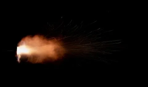 The texture of a firearm shot , a bright flash of flame on a black background Foto stock