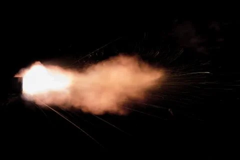 The texture of a firearm shot , a bright flash of flame on a black background Stock Photos