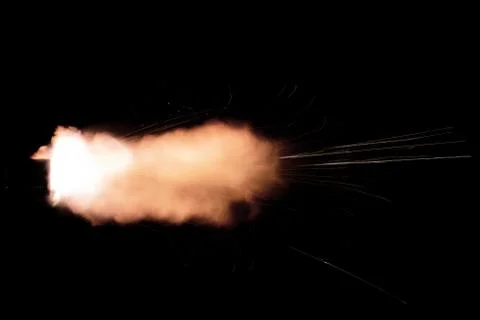 The texture of a firearm shot , a bright flash of flame on a black background Stock Photos