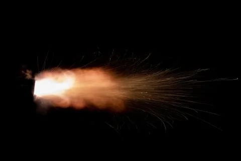 The texture of a firearm shot , a bright flash of flame on a black background Stock Photos