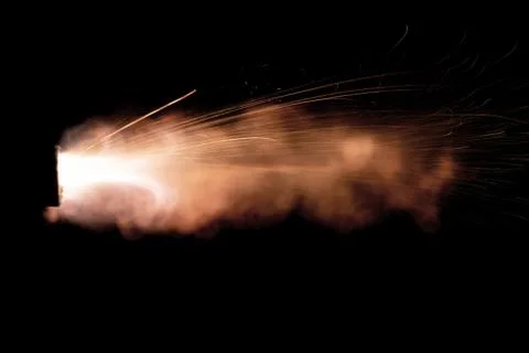 The texture of a firearm shot , a bright flash of flame on a black background Stock Photos