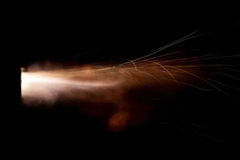 The texture of a firearm shot , a bright flash of flame on a black background Stock Photos