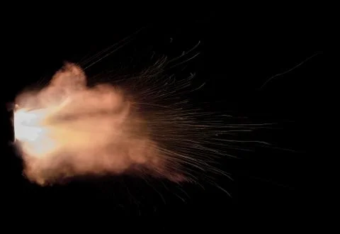 The texture of a firearm shot , a bright flash of flame on a black background Stock Photos