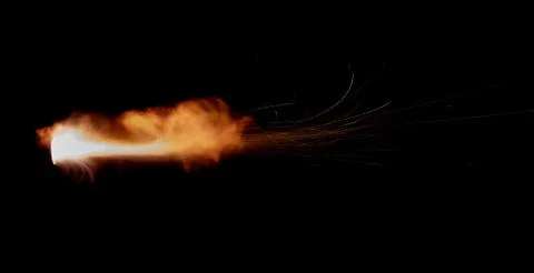 The texture of a firearm shot , a bright flash of flame on a black background Stock Photos