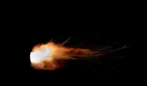 The texture of a firearm shot , a bright flash of flame on a black background Stock Photos