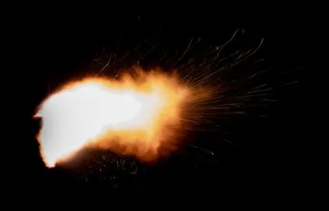 The texture of a firearm shot , a bright flash of flame on a black background Stock Photos