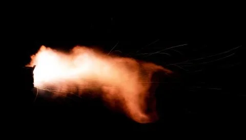 The texture of a firearm shot , a bright flash of flame on a black background Stock Photos