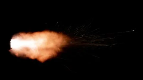 The texture of a firearm shot , a bright flash of flame on a black background Stock Photos